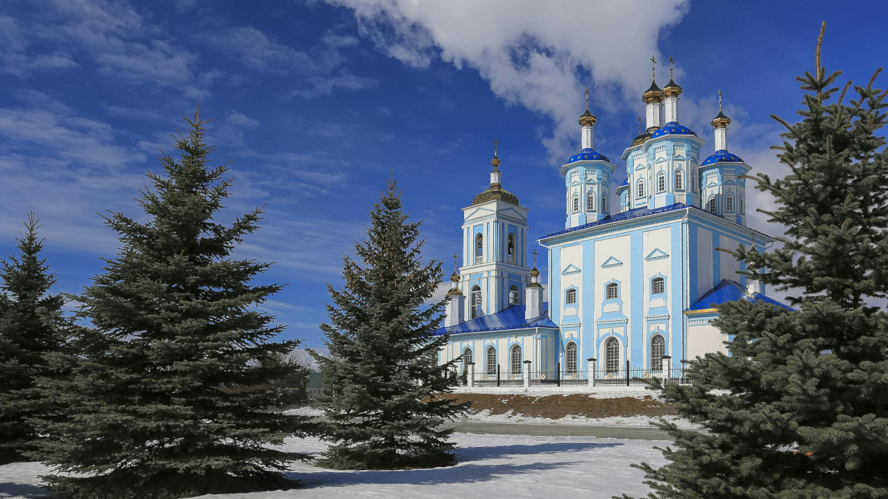 Голубой храм с синими маковками на фоне синего, морозного неба